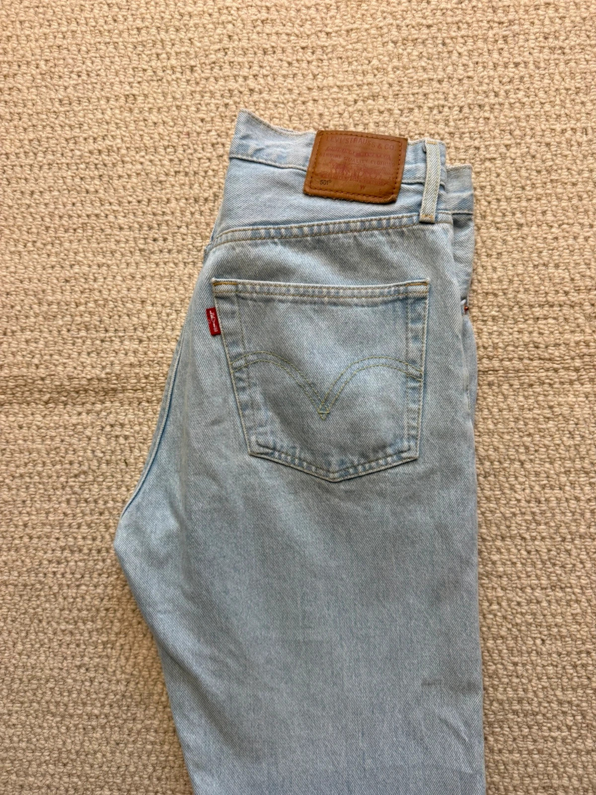 Levi's blue high rise straight jeans with button fly and premium label.