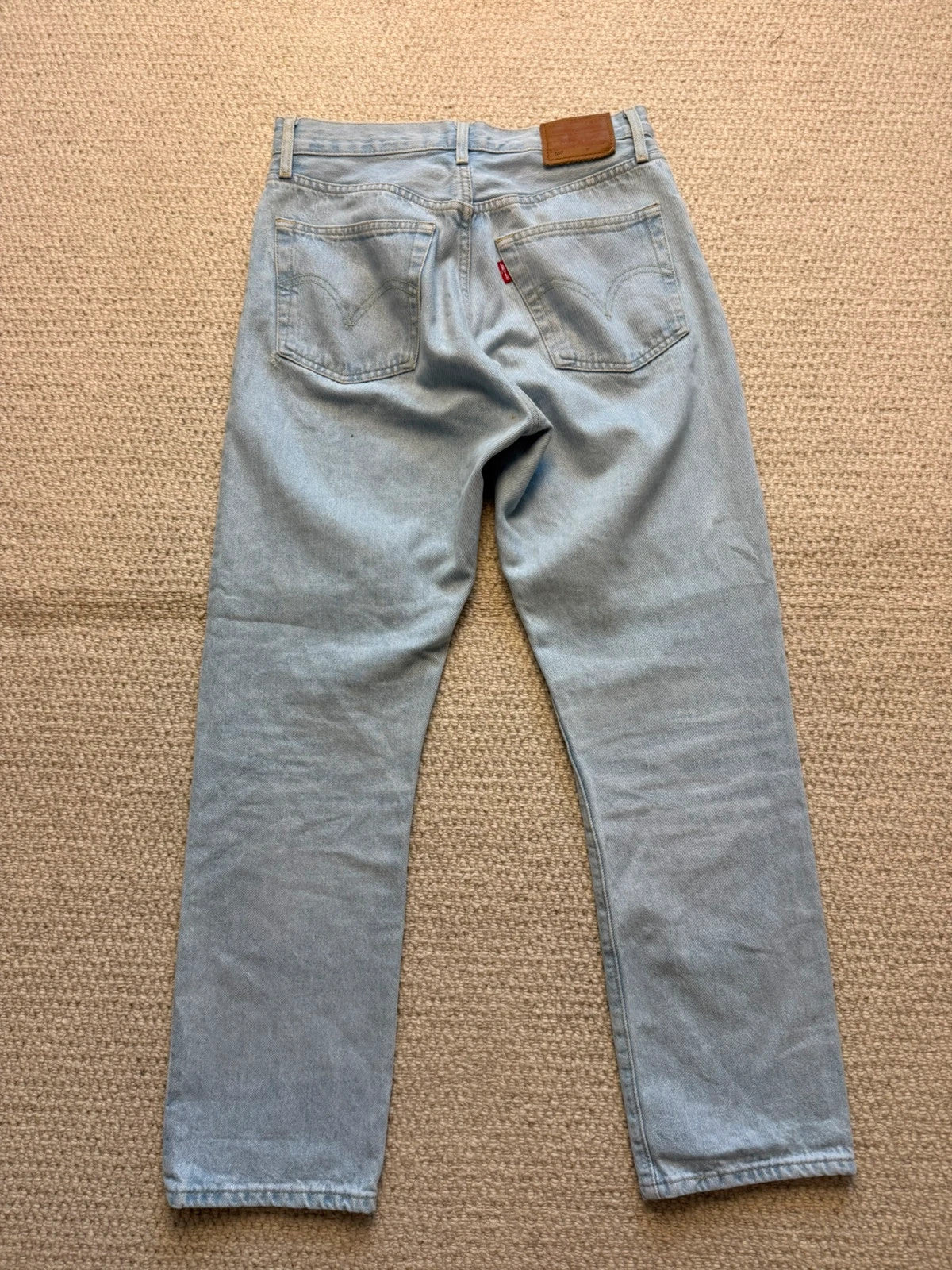 Levi's blue high rise straight jeans with button fly and premium label.