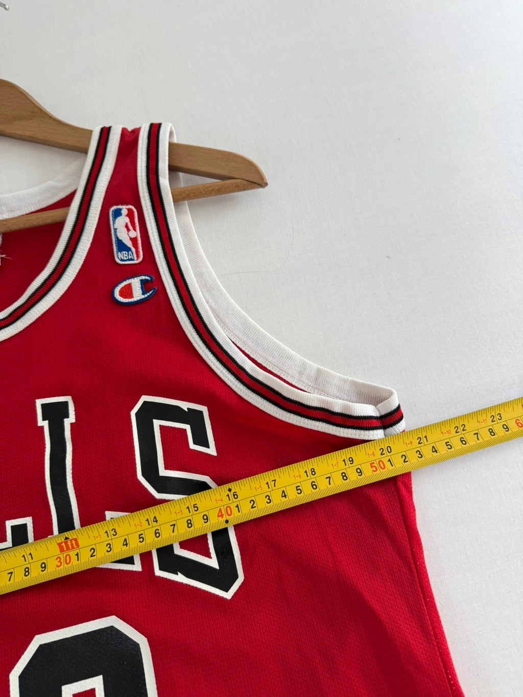 Champion red graphic tee featuring Jordan appliqué, NBA logo embroidery, and ribbed trim.