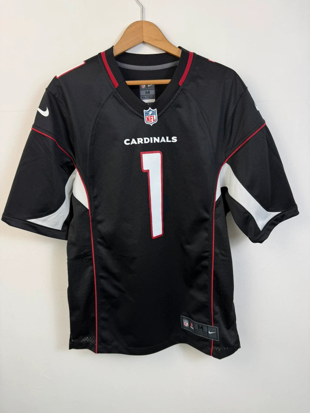 Nike graphic tee black with Arizona Cardinals logo, red and white piping, and NFL shield.