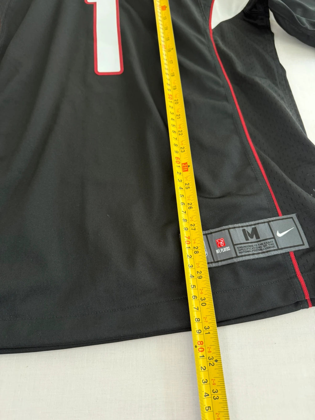 Nike graphic tee black with Arizona Cardinals logo, red and white piping, and NFL shield.