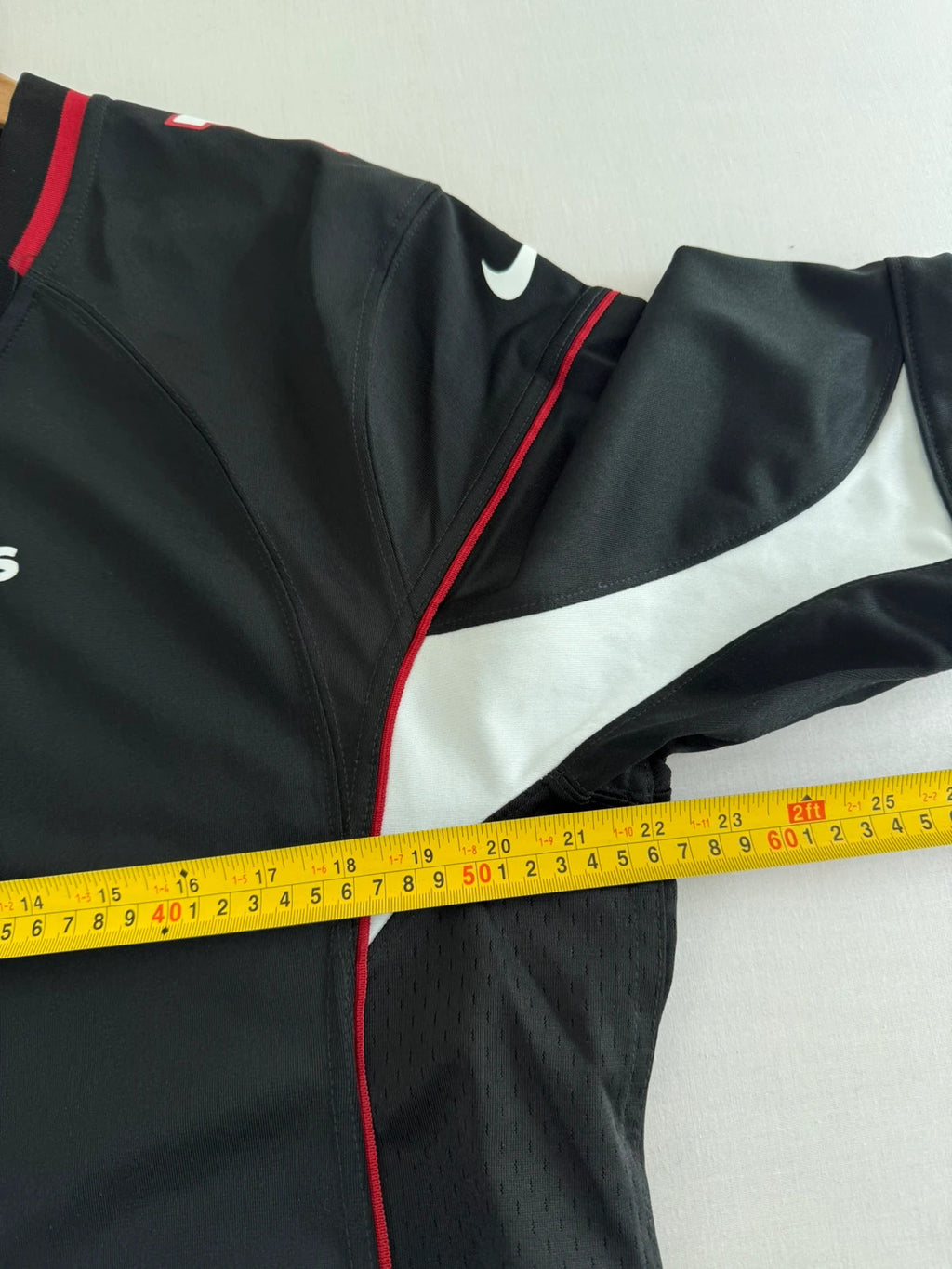 Nike graphic tee black with Arizona Cardinals logo, red and white piping, and NFL shield.