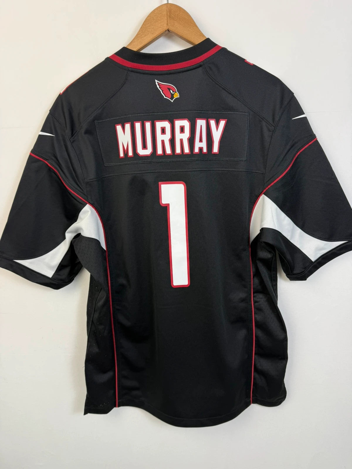Nike graphic tee black with Arizona Cardinals logo, red and white piping, and NFL shield.