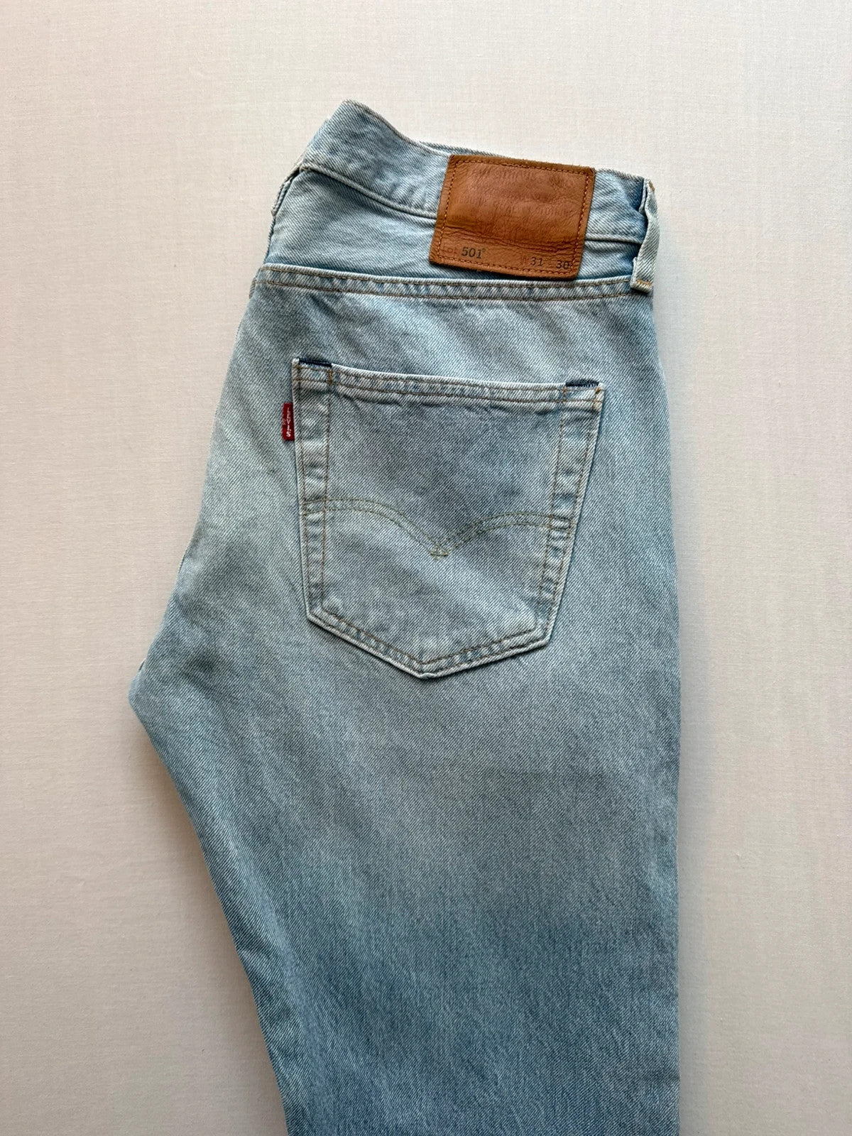Levi's light blue straight jeans with button fly and signature back pocket stitching.