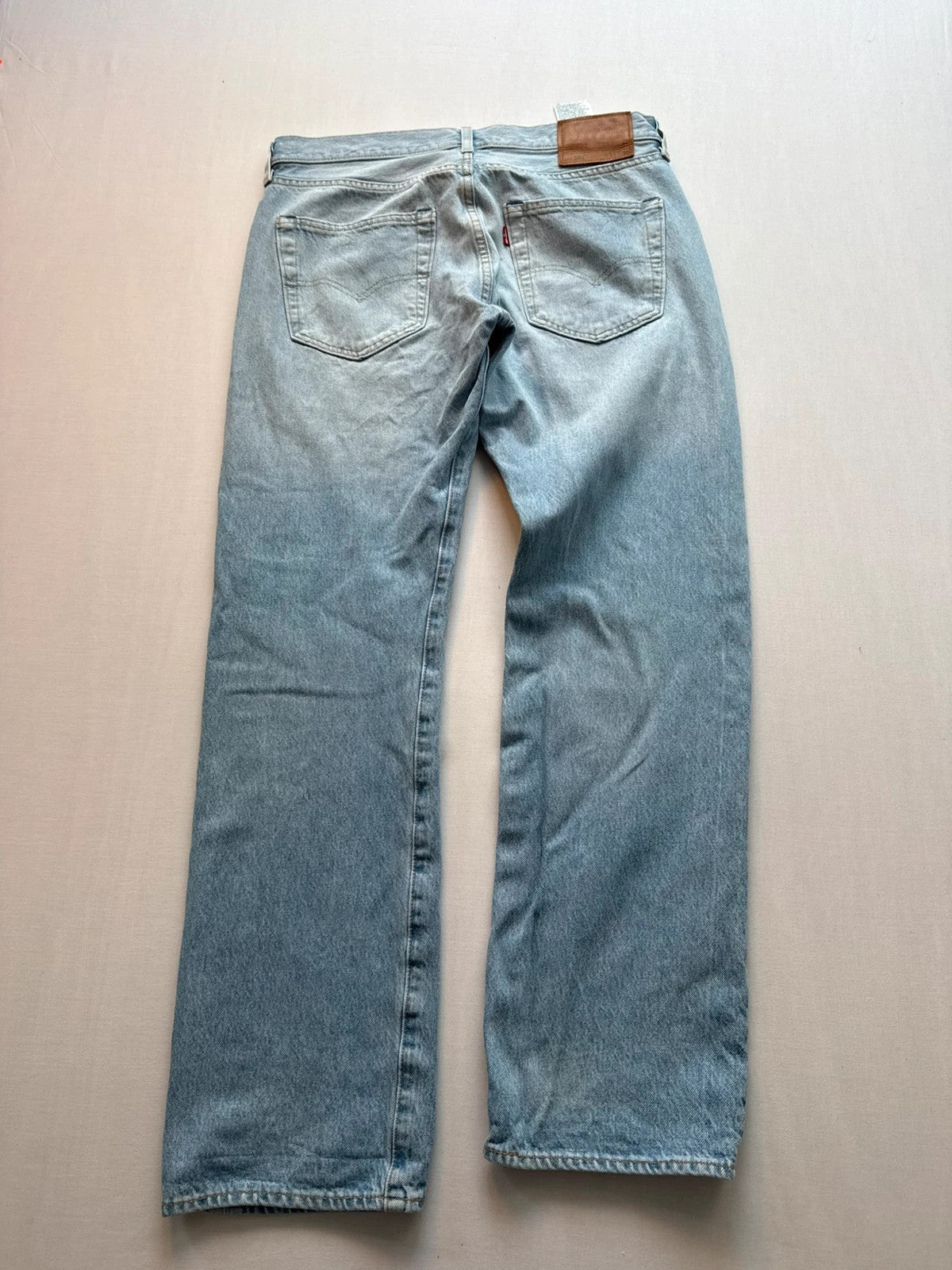 Levi's light blue straight jeans with button fly and signature back pocket stitching.