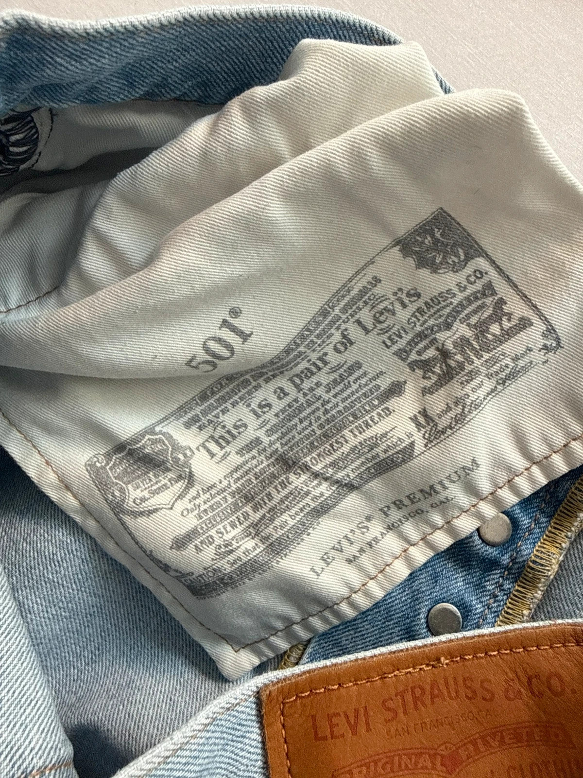 Levi's light blue straight jeans with button fly and signature back pocket stitching.