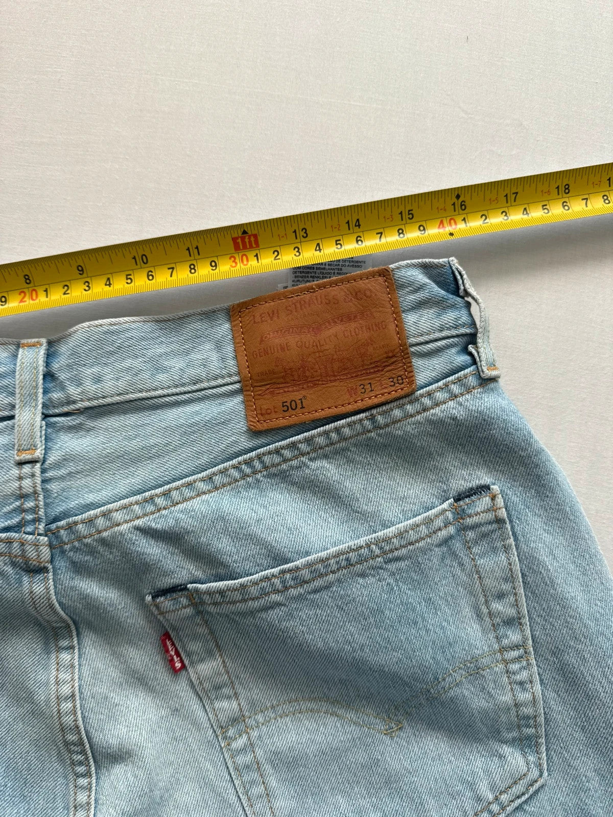 Levi's light blue straight jeans with button fly and signature back pocket stitching.