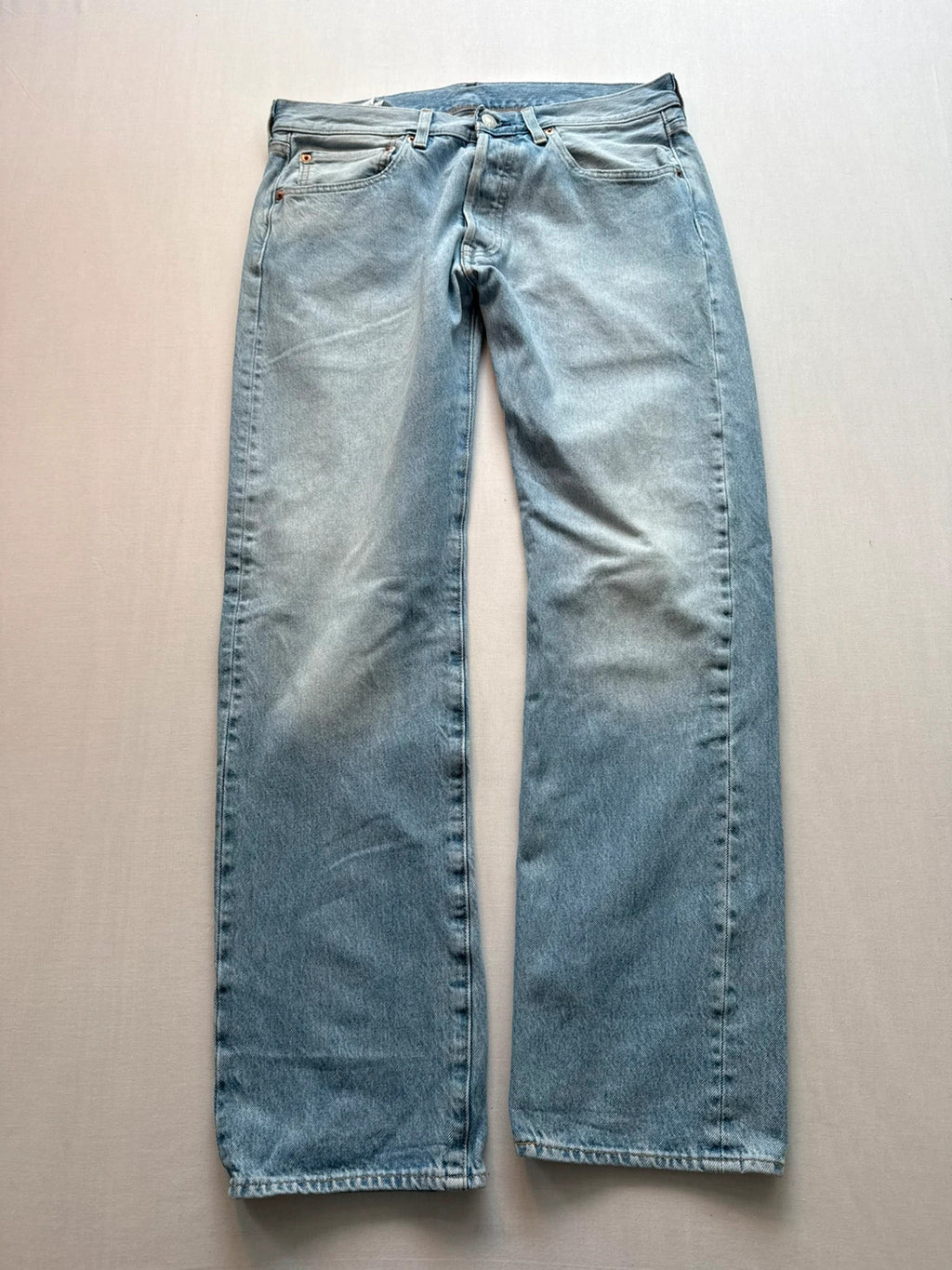 Levi's light blue straight jeans with button fly and signature back pocket stitching.
