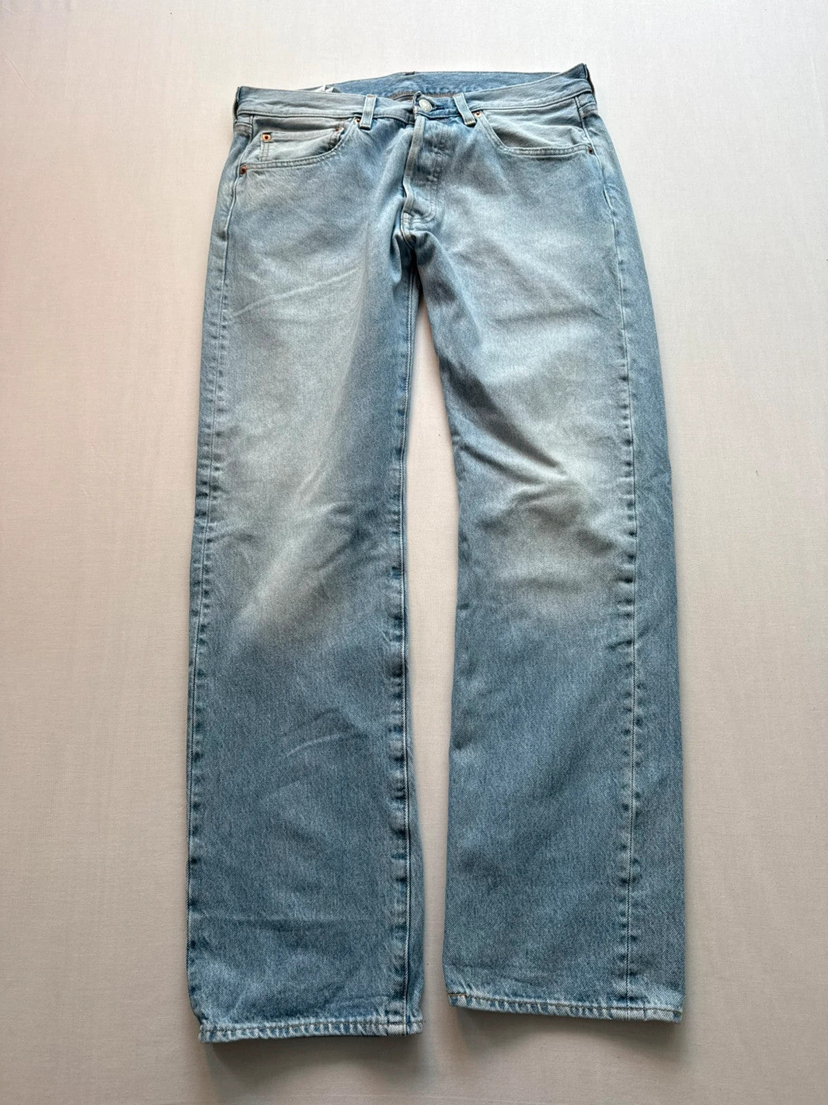 Levi's light blue straight jeans with button fly and signature back pocket stitching.