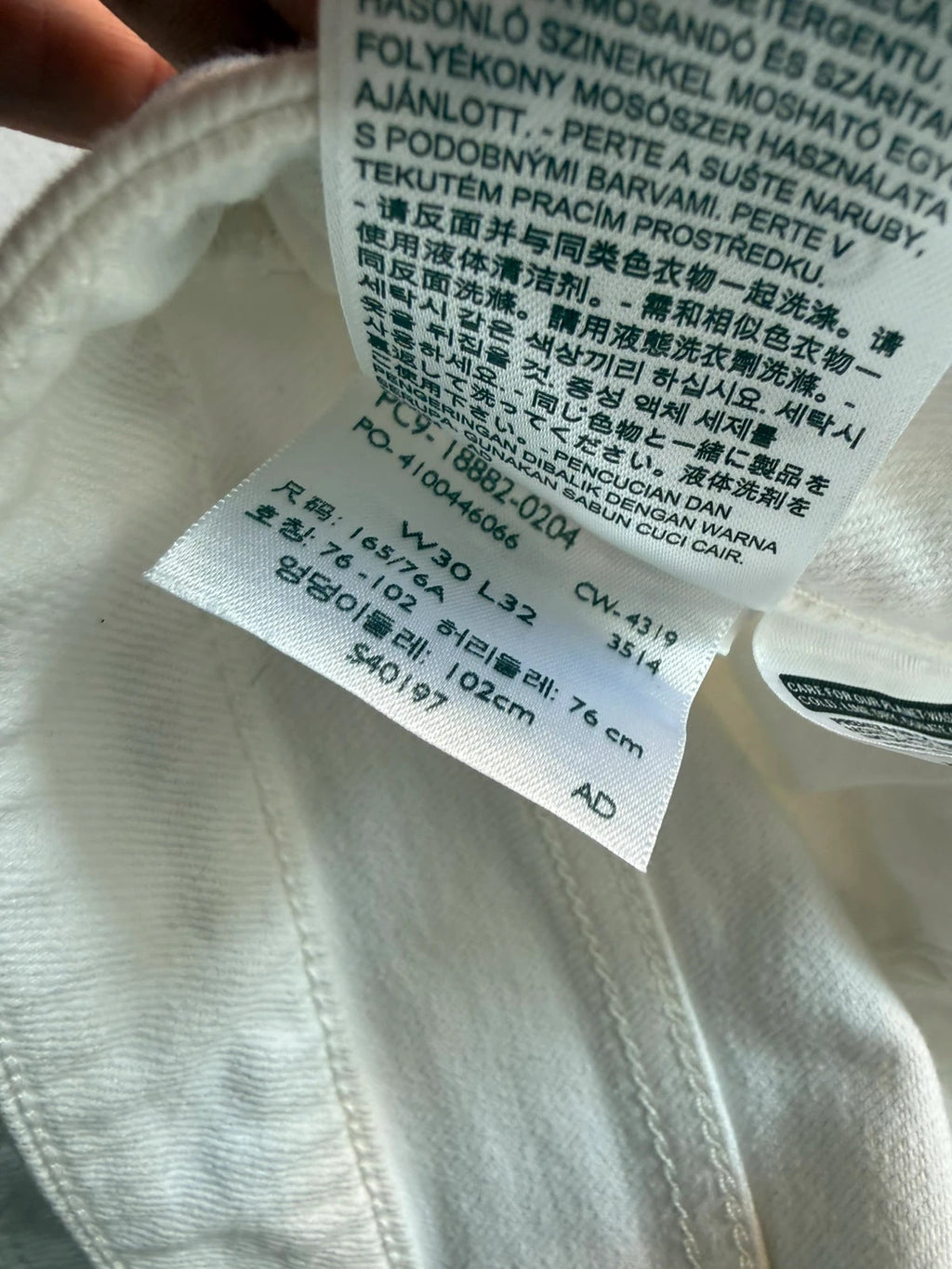 Levi's white high rise skinny jeans with five-pocket styling and zip fly.
