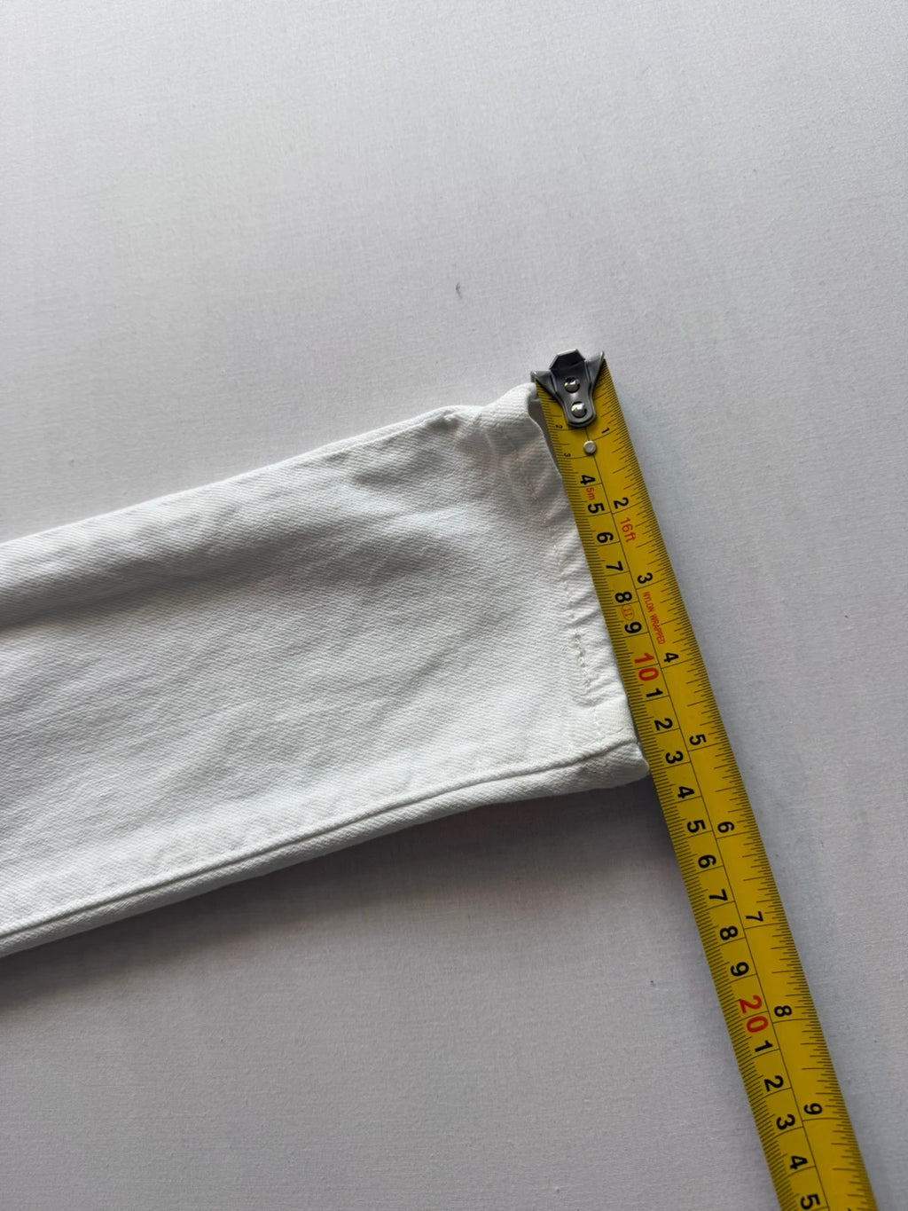 Levi's white high rise skinny jeans with five-pocket styling and zip fly.