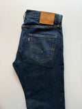 Levi's dark indigo slim taper jeans with classic five-pocket styling and signature stitching.