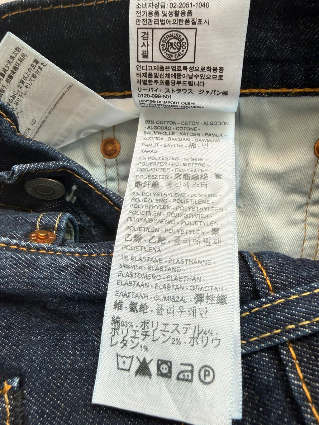 Levi's dark indigo slim taper jeans with classic five-pocket styling and signature stitching.