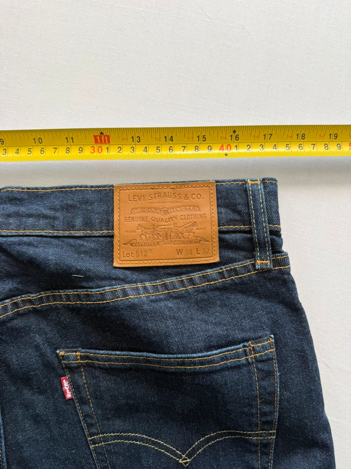 Levi's dark indigo slim taper jeans with classic five-pocket styling and signature stitching.