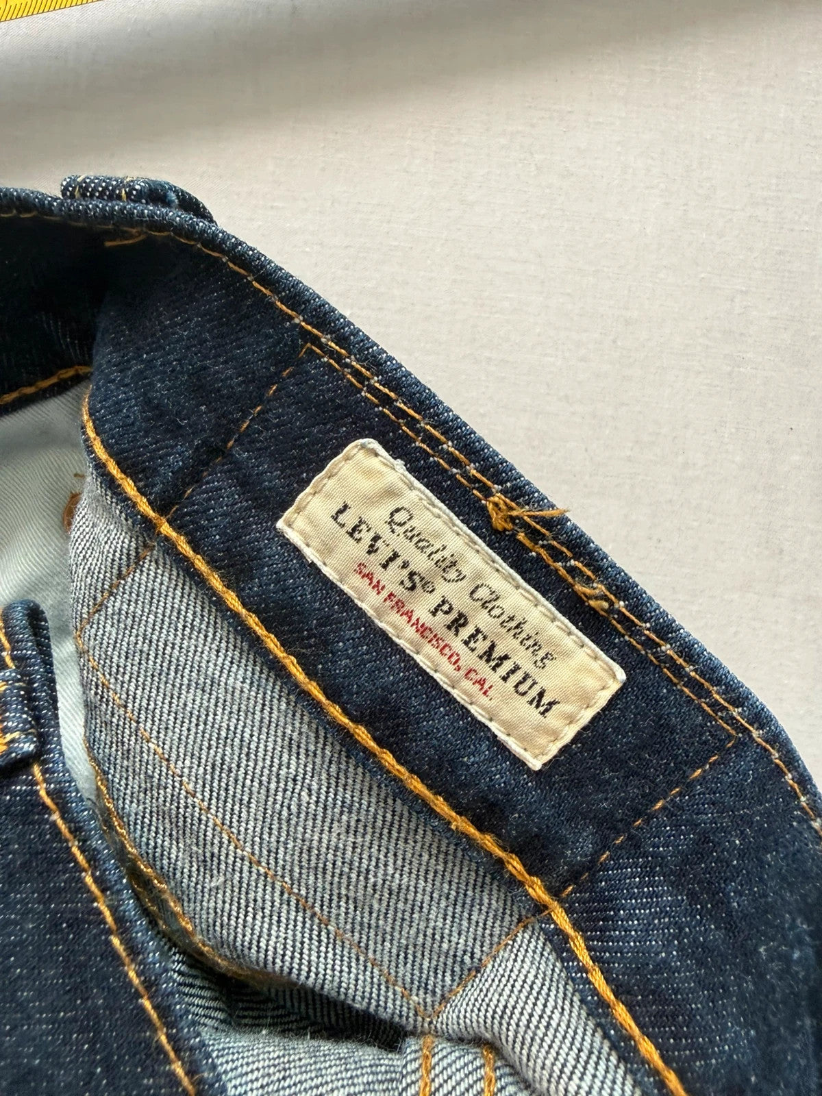 Levi's dark indigo slim taper jeans with classic five-pocket styling and signature stitching.