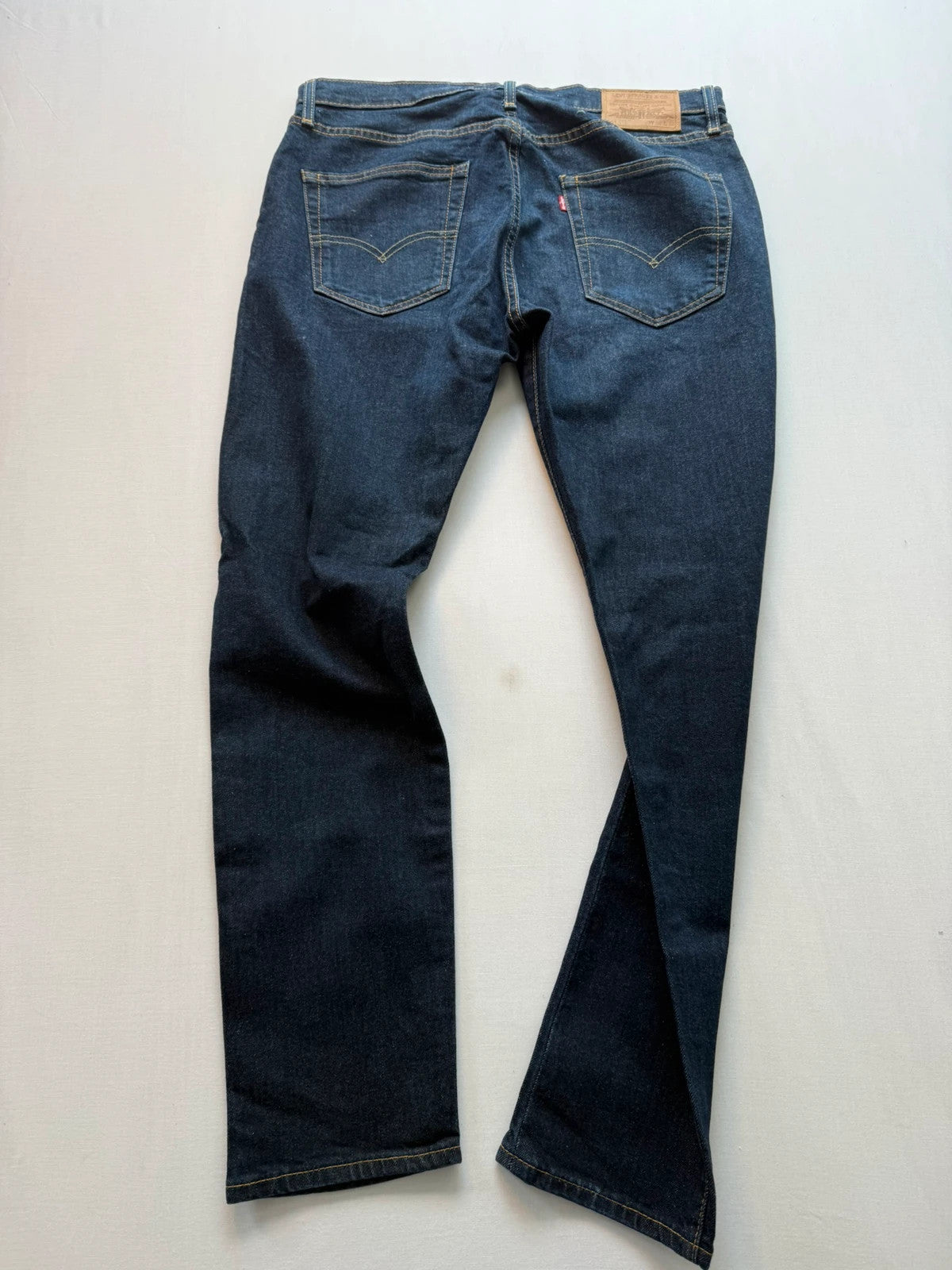 Levi's dark indigo slim taper jeans with classic five-pocket styling and signature stitching.