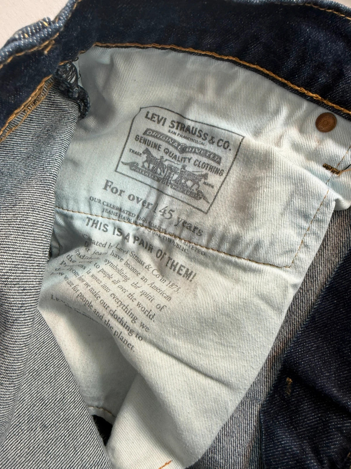 Levi's dark indigo slim taper jeans with classic five-pocket styling and signature stitching.