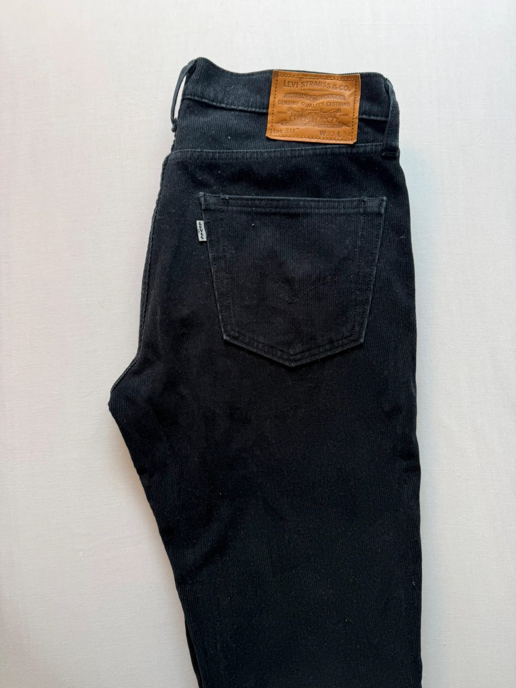 Levi's black straight jeans with classic five-pocket styling and signature back pocket stitching.