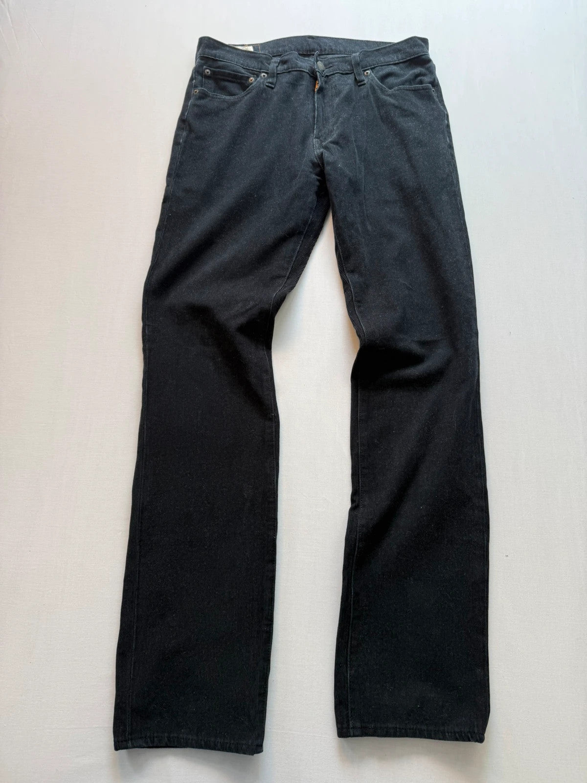 Levi's black straight jeans with classic five-pocket styling and signature back pocket stitching.