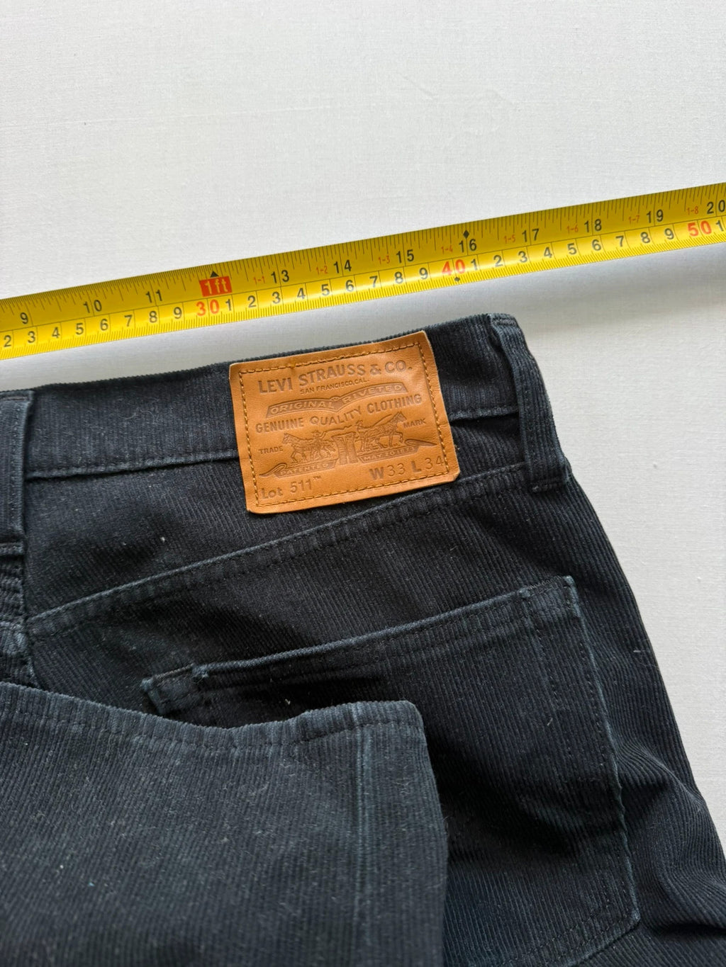 Levi's black straight jeans with classic five-pocket styling and signature back pocket stitching.
