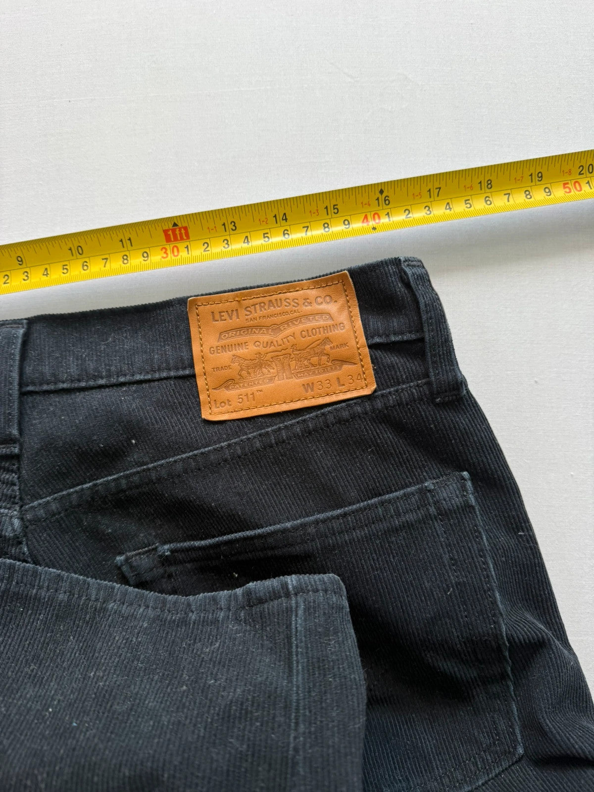 Levi's black straight jeans with classic five-pocket styling and signature back pocket stitching.