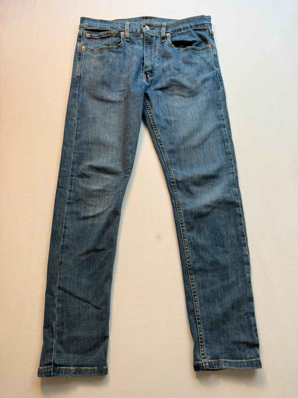 Levi's blue straight jeans with classic five-pocket styling and tapered leg.