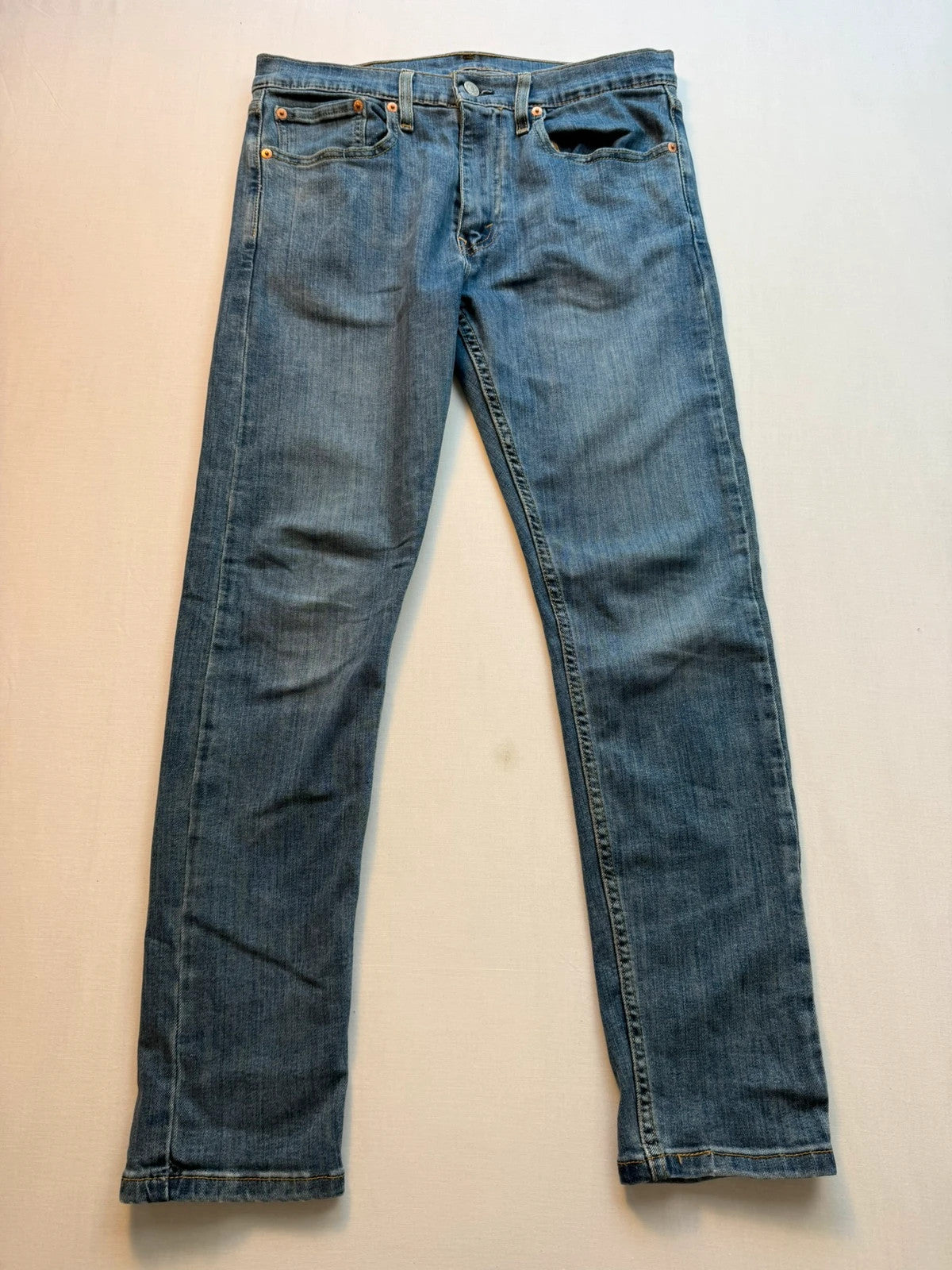 Levi's blue straight jeans with classic five-pocket styling and tapered leg.