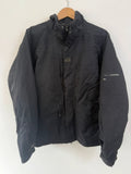 Helly Hansen black ski jacket with waterproof shell, mesh-vented pockets, and adjustable cuffs.