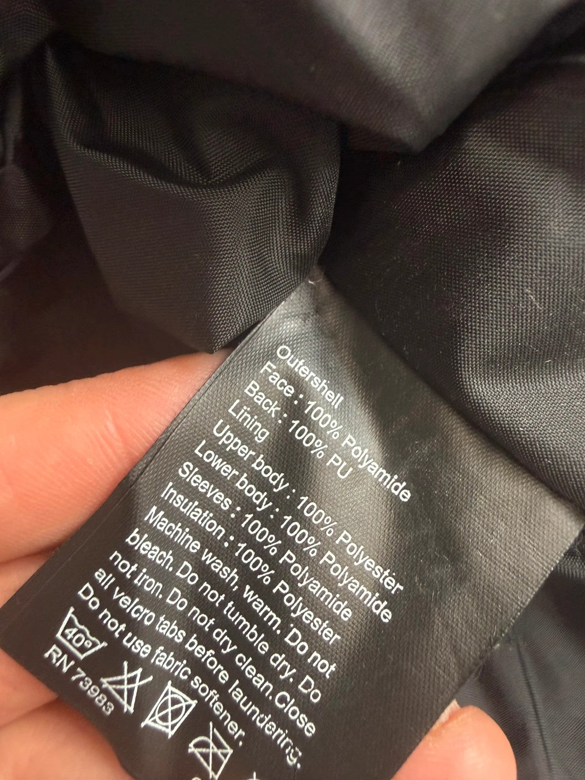 Helly Hansen black ski jacket with waterproof shell, mesh-vented pockets, and adjustable cuffs.