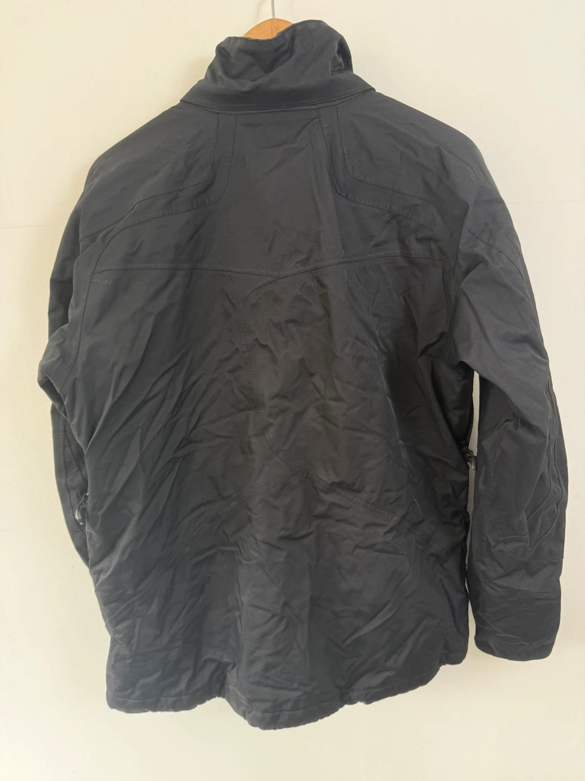 Helly Hansen black ski jacket with waterproof shell, mesh-vented pockets, and adjustable cuffs.
