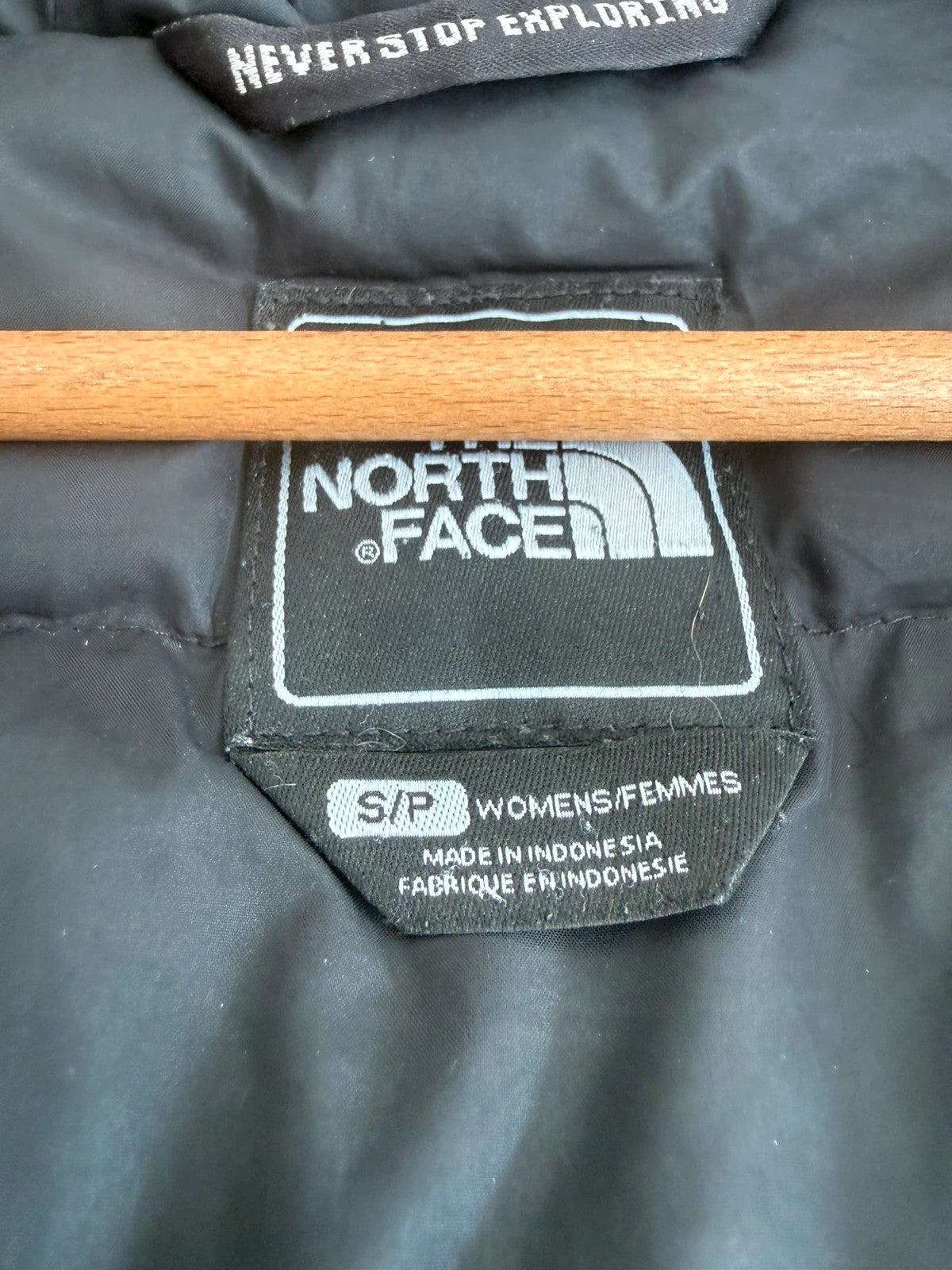 The North Face grey parka with adjustable faux fur hood and belted waist.