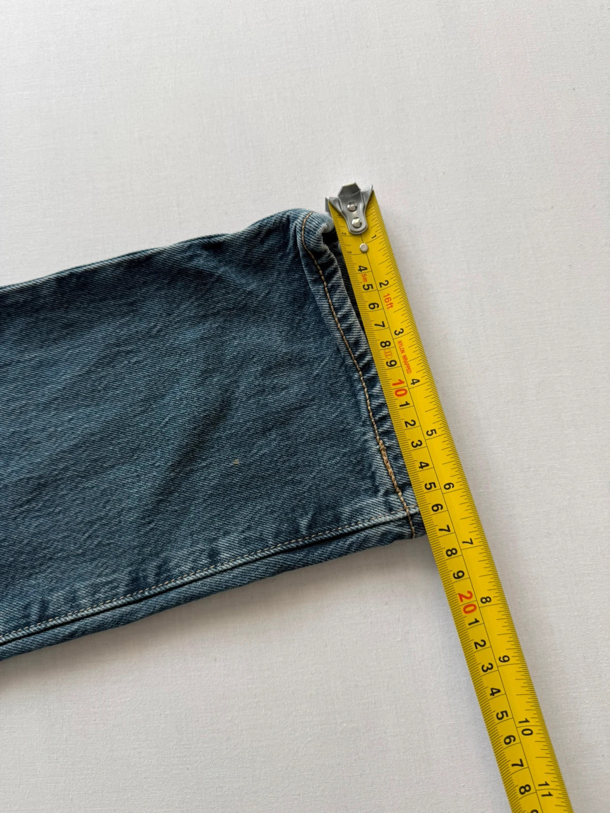 Levi's blue tapered jeans with classic 501 cut and subtle stretch detail.