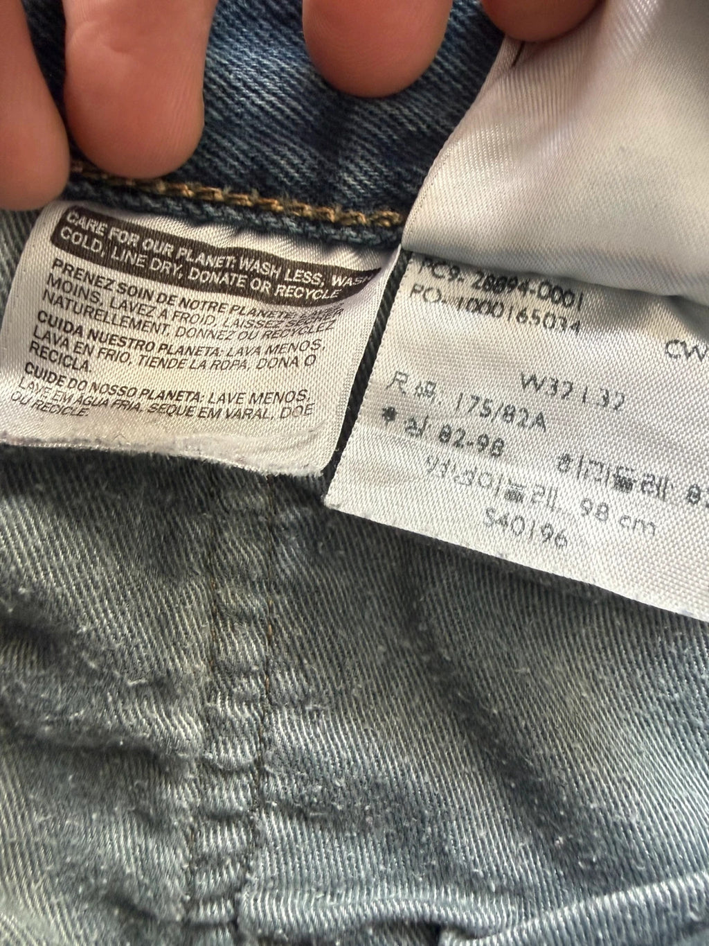 Levi's blue tapered jeans with classic 501 cut and subtle stretch detail.