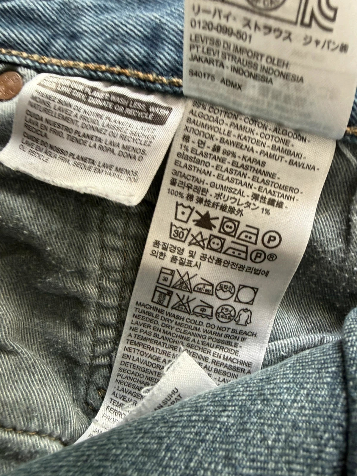 Levi's blue tapered jeans with classic 501 cut and subtle stretch detail.