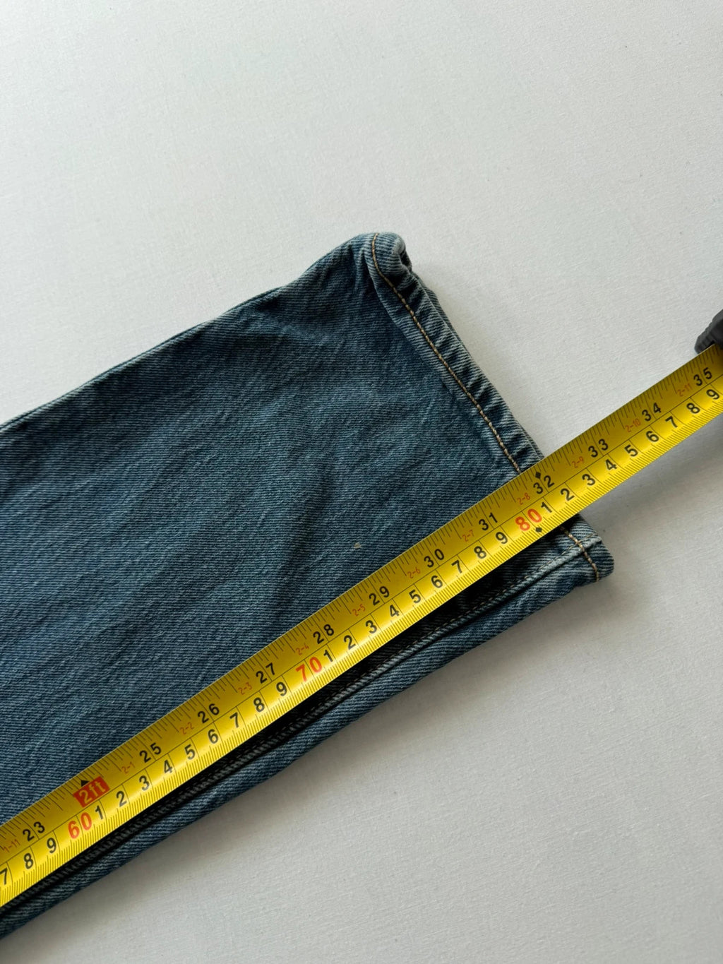Levi's blue tapered jeans with classic 501 cut and subtle stretch detail.