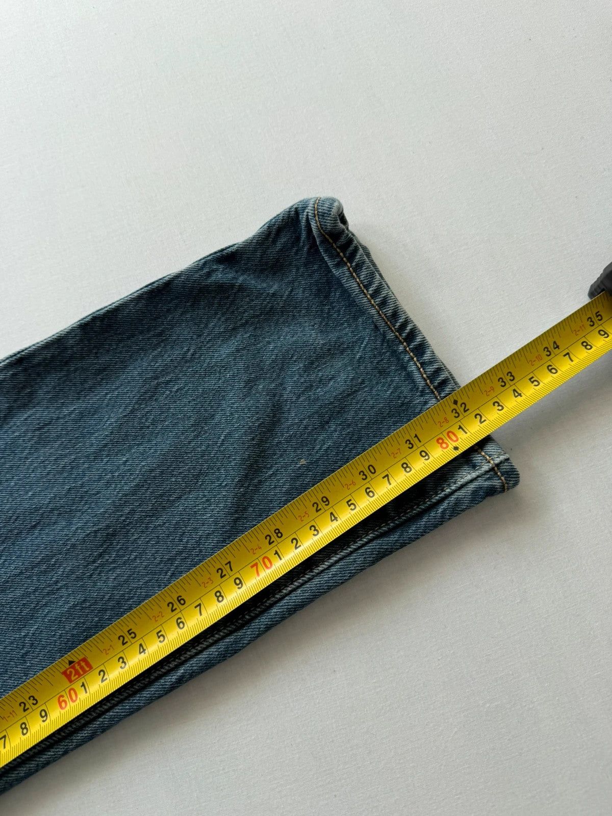Levi's blue tapered jeans with classic 501 cut and subtle stretch detail.