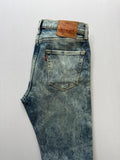 Levi's light blue acid wash tapered jeans with classic five-pocket styling and leather patch.
