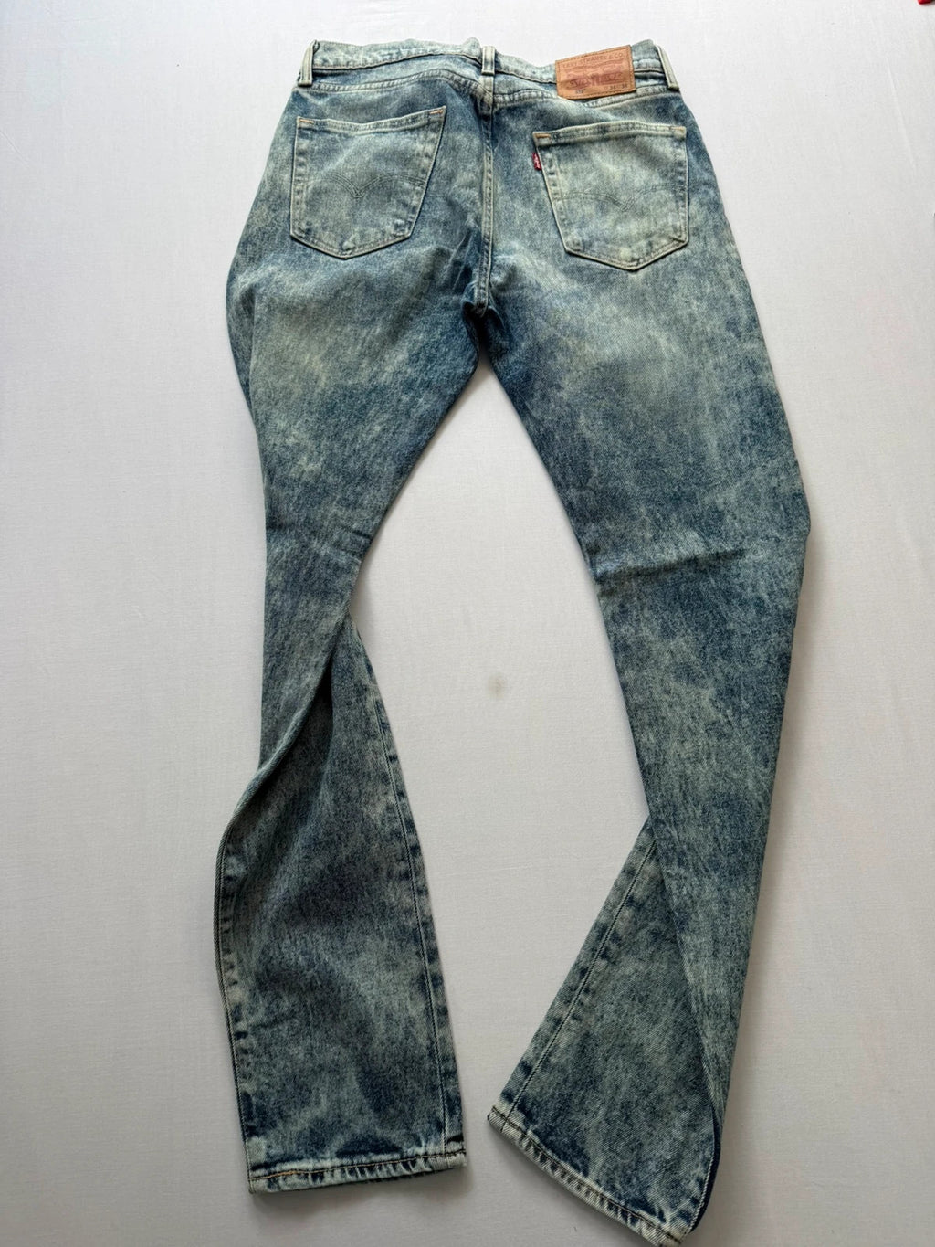 Levi's light blue acid wash tapered jeans with classic five-pocket styling and leather patch.