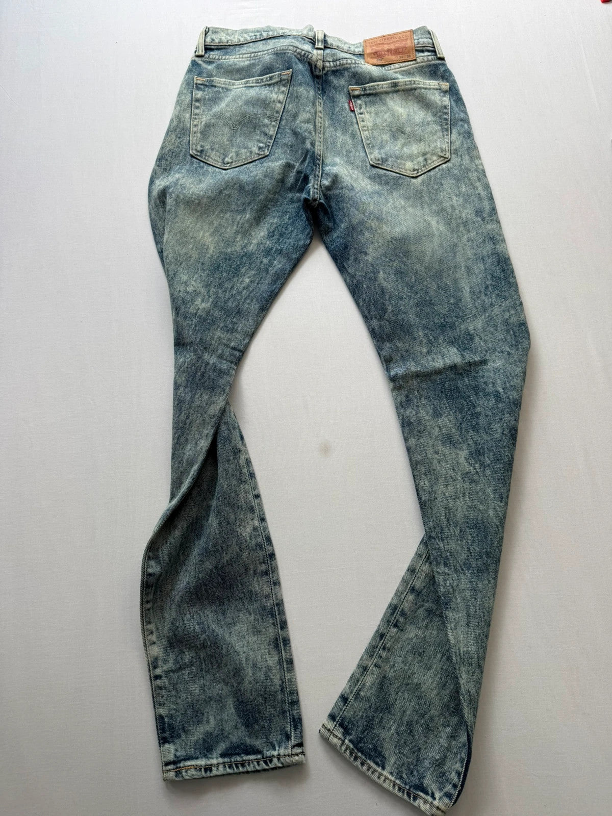 Levi's light blue acid wash tapered jeans with classic five-pocket styling and leather patch.
