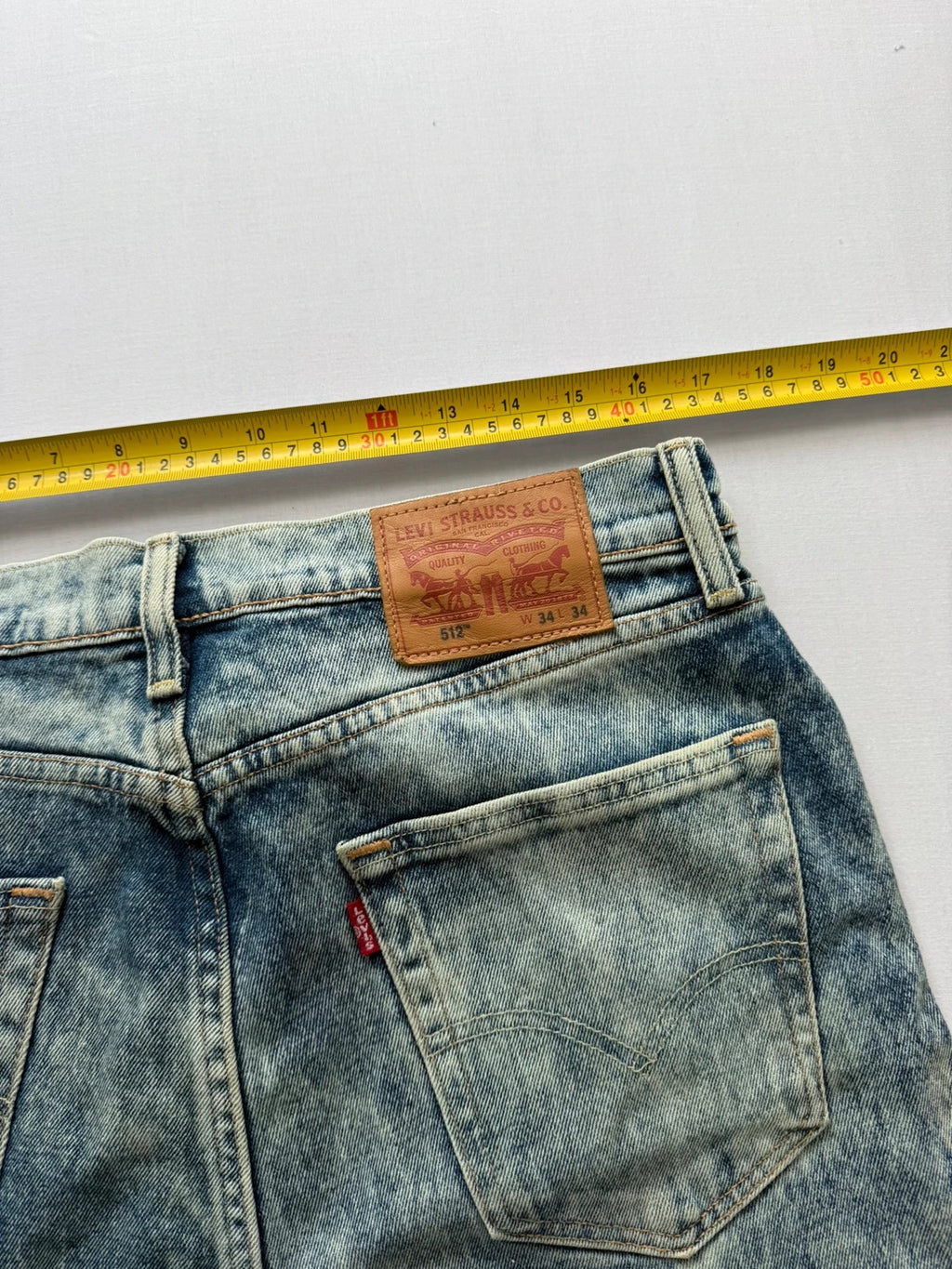 Levi's light blue acid wash tapered jeans with classic five-pocket styling and leather patch.
