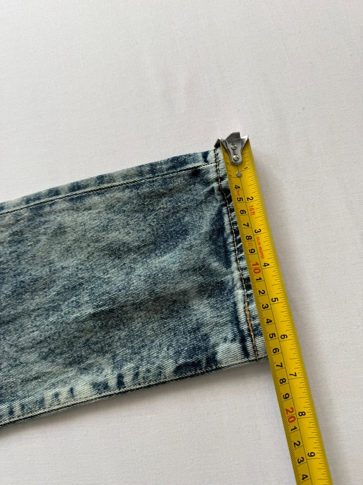 Levi's light blue acid wash tapered jeans with classic five-pocket styling and leather patch.