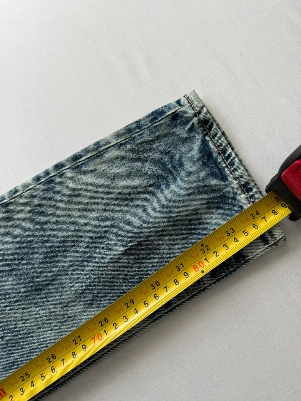 Levi's light blue acid wash tapered jeans with classic five-pocket styling and leather patch.