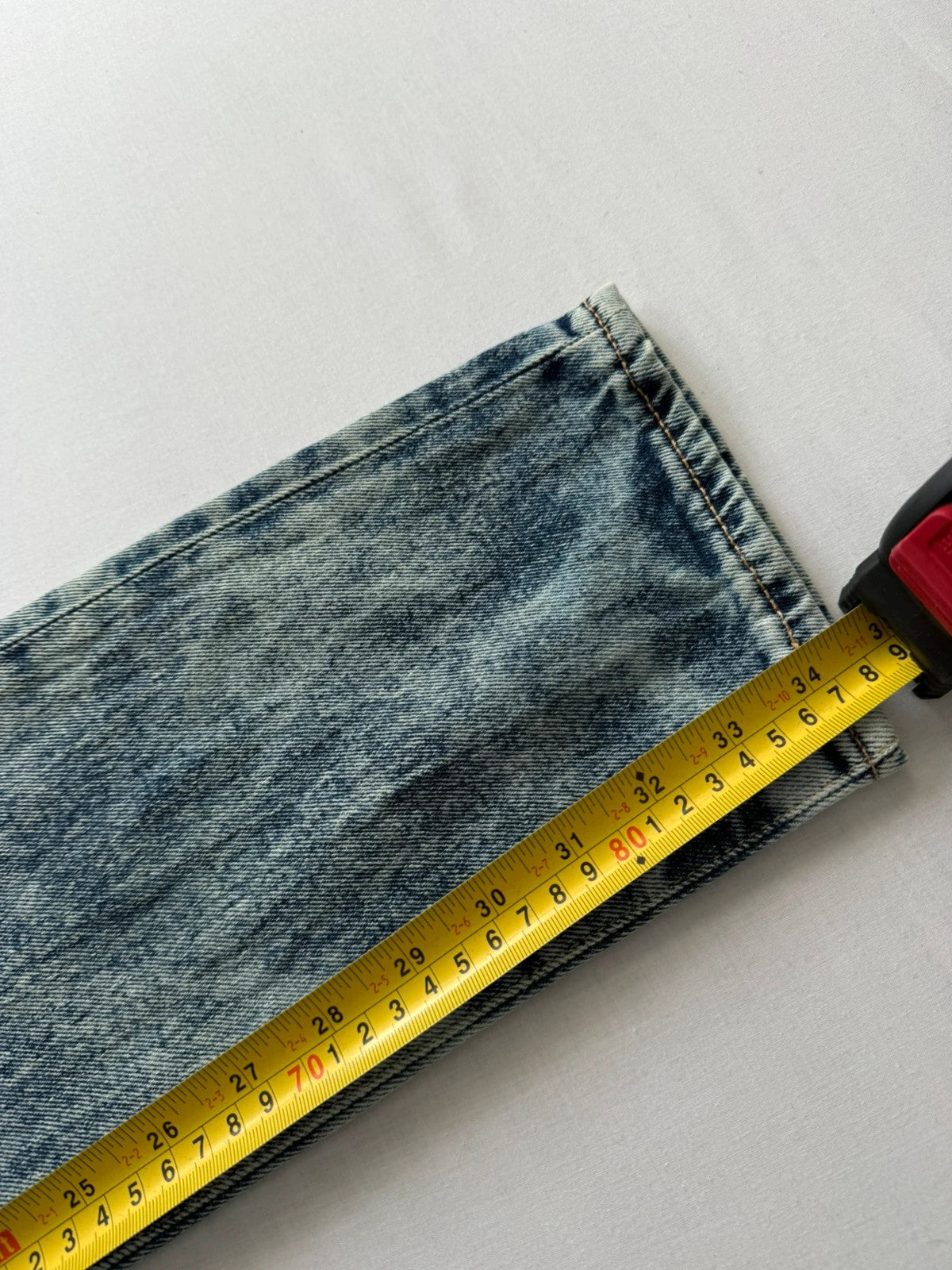 Levi's light blue acid wash tapered jeans with classic five-pocket styling and leather patch.