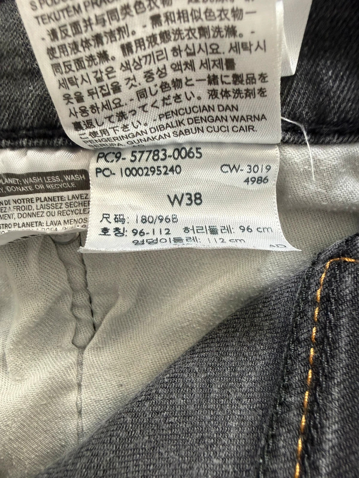 Levi's grey tapered jeans with classic 5-pocket styling and signature back stitching.