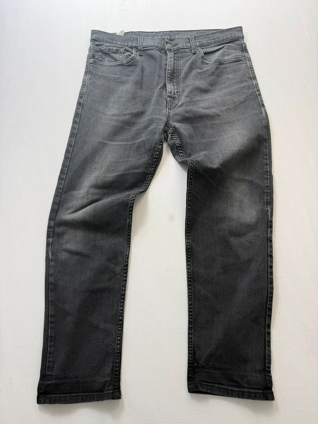 Levi's grey tapered jeans with classic 5-pocket styling and signature back stitching.