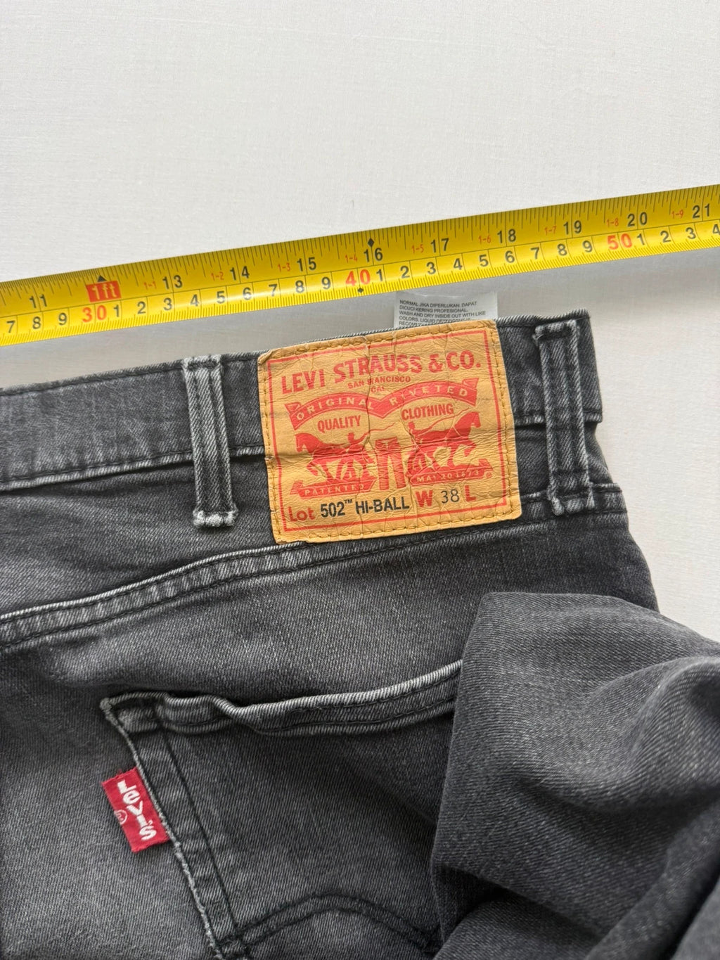 Levi's grey tapered jeans with classic 5-pocket styling and signature back stitching.