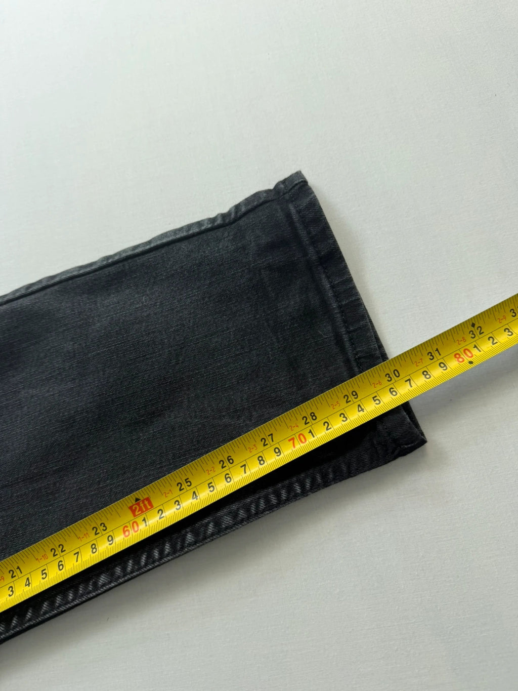 Levi's grey tapered jeans with classic 5-pocket styling and signature back stitching.