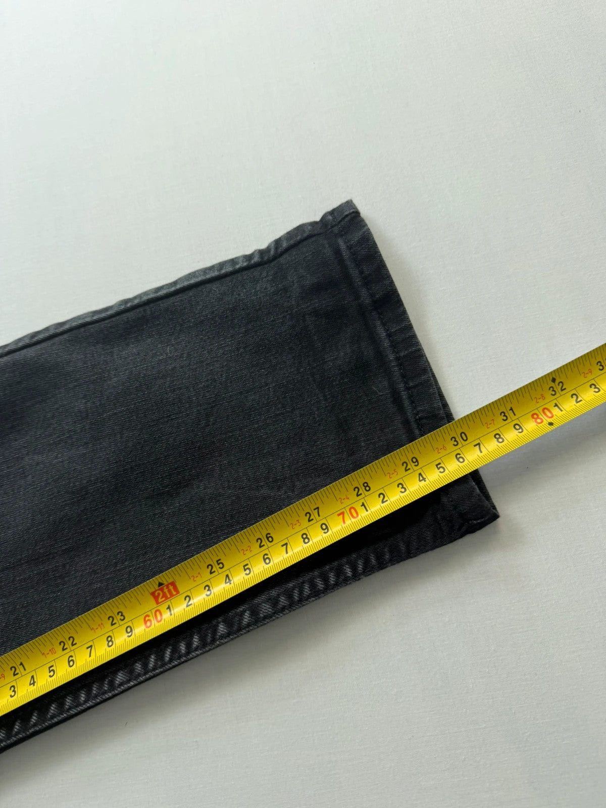 Levi's grey tapered jeans with classic 5-pocket styling and signature back stitching.