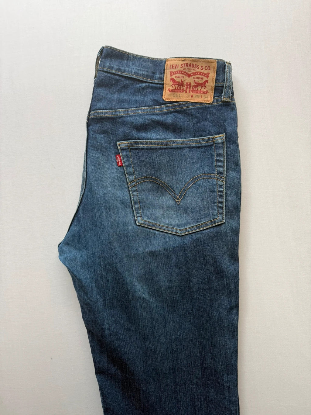 Levi's blue straight jeans with classic 5-pocket styling and signature back stitching.