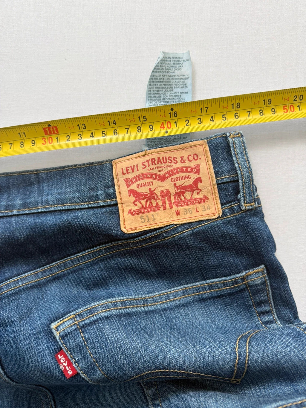 Levi's blue straight jeans with classic 5-pocket styling and signature back stitching.